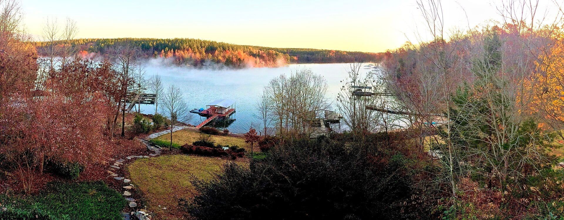 Morning mist over Lake Keowee, with docks along a wooded shore